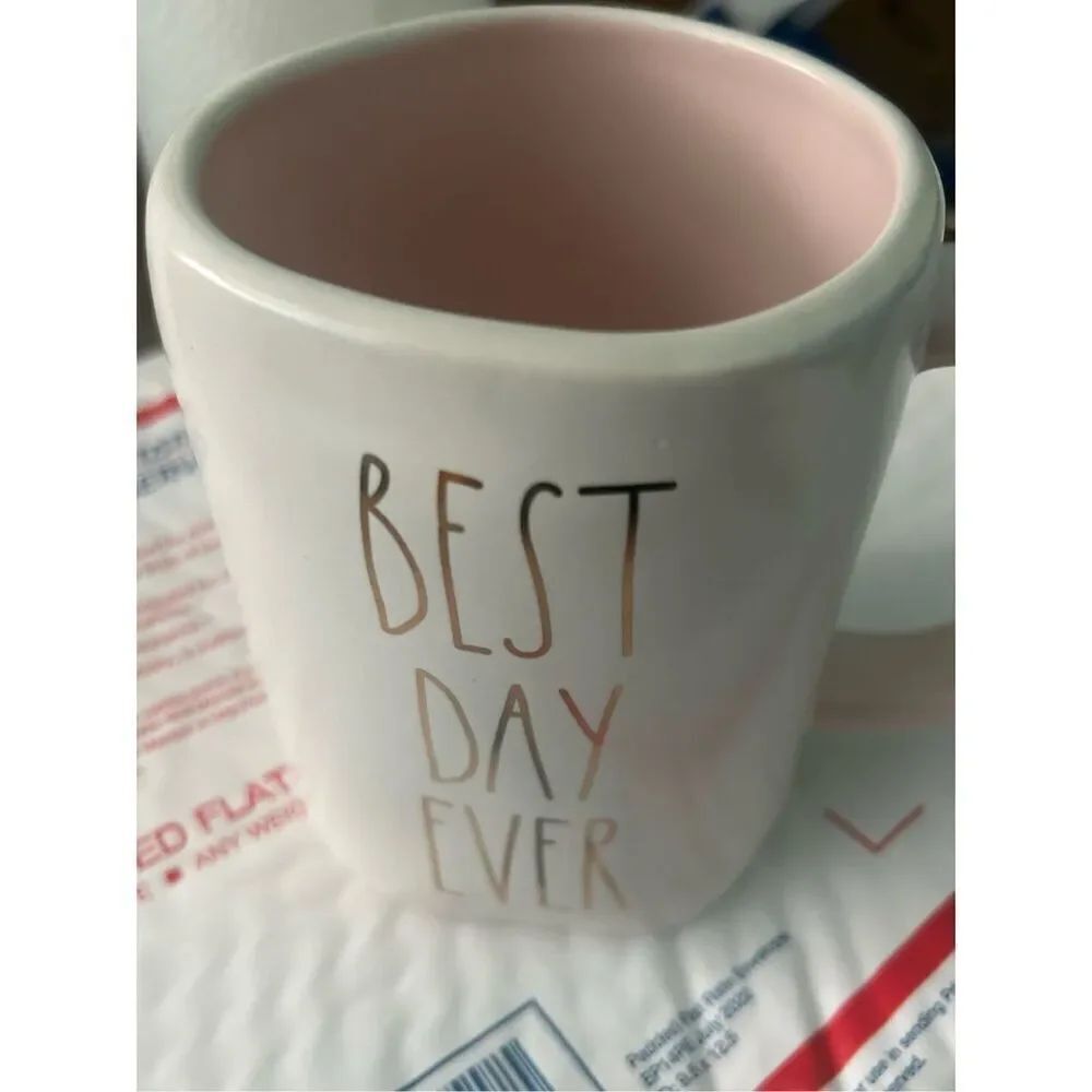 BEST DAY EVER mug. White in color with gold lettering. Pink inside and handle